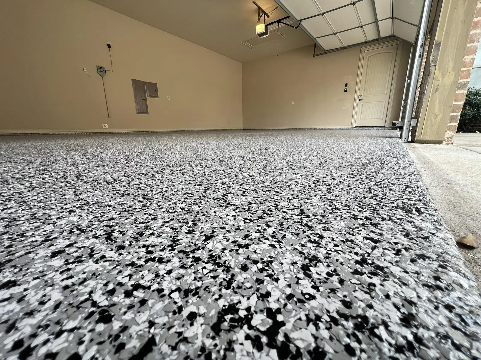 Gray, black and white flake coating on a garage floor