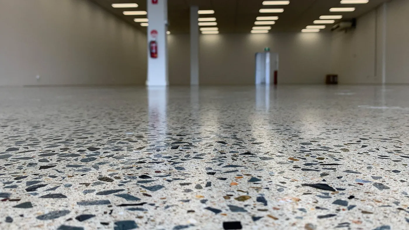 Ground and sealed concrete floor with exposed aggregate in a commercial space
