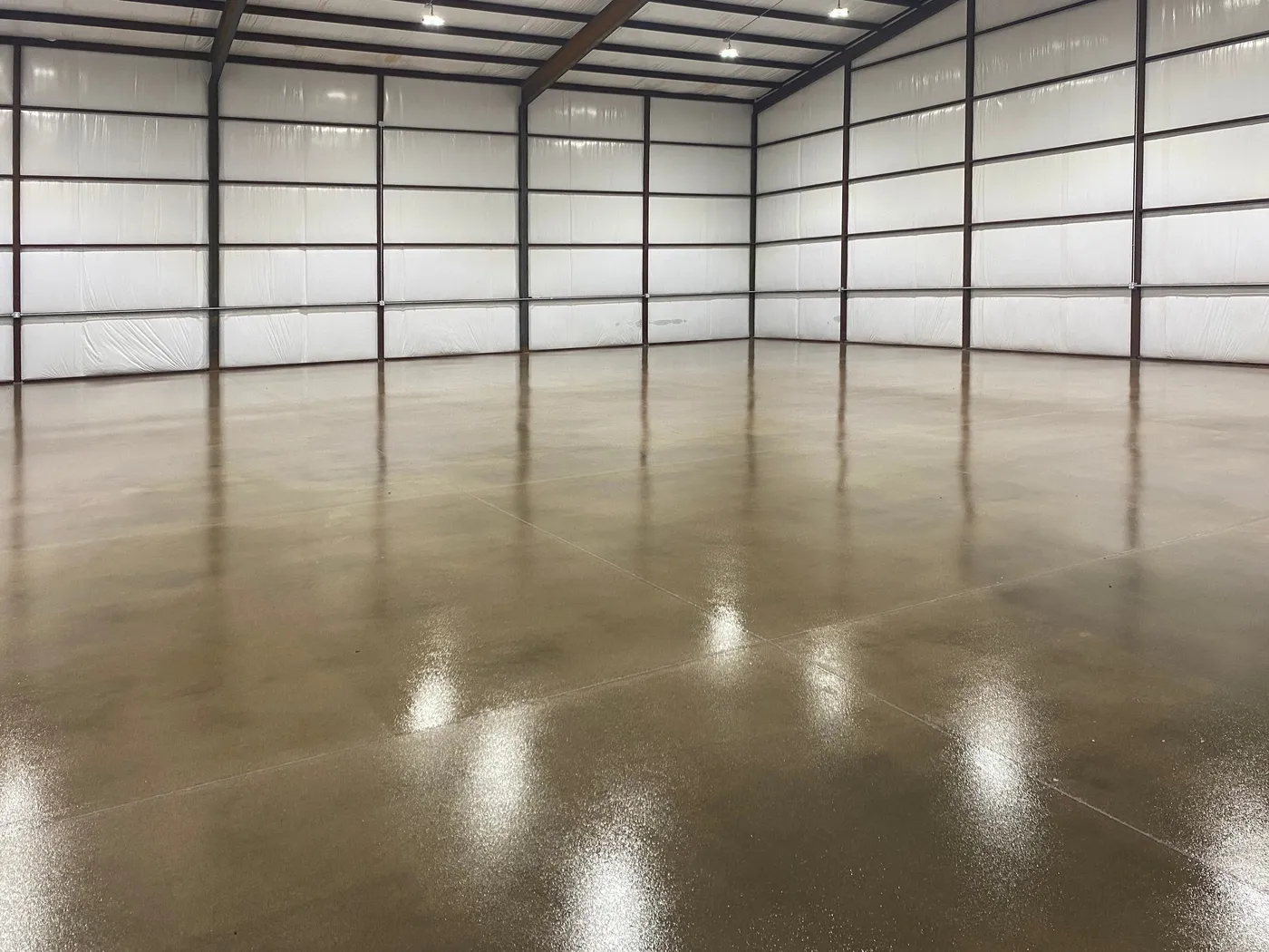 Sealed concrete floor in an empty commercial warehouse bay